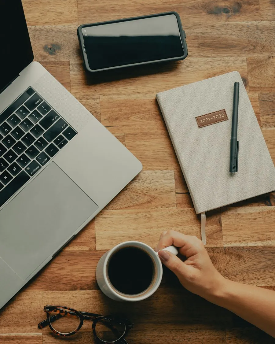 Planning desk with laptop, notebook, and coffee for a Salesforce strategy