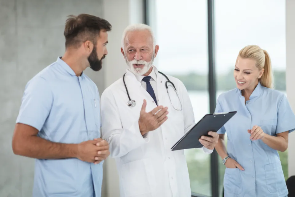 Doctor and nurses reviewing a patient chart on a tablet
